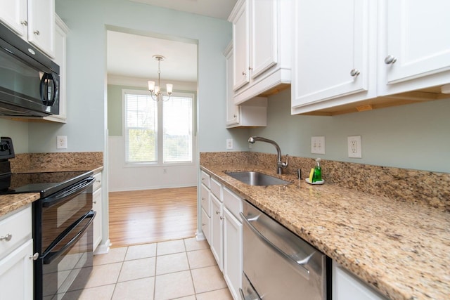 kitchen featuring light stone countertops, sink, white cabinets, and black appliances