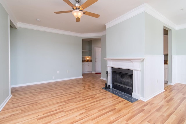 unfurnished living room featuring ceiling fan, light wood-type flooring, and ornamental molding