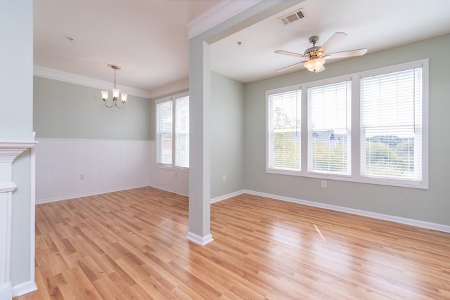 unfurnished living room featuring crown molding, light hardwood / wood-style flooring, and ceiling fan with notable chandelier