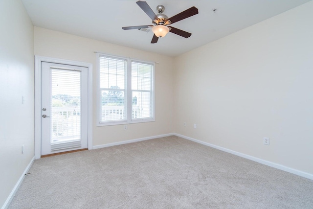 spare room featuring ceiling fan and light colored carpet