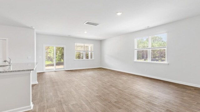 54 Twickenham Loop, Yemassee, SC 29945 - unfurnished living room with plenty of natural light, light wood finished floors, and recessed lighting