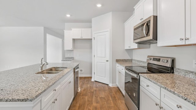 54 Twickenham Loop, Yemassee, SC 29945 - kitchen with appliances with stainless steel finishes, white cabinets, wood finished floors, recessed lighting, and light stone countertops