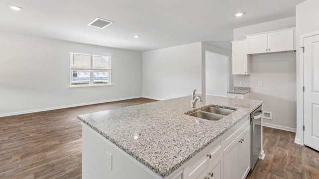 54 Twickenham Loop, Yemassee, SC 29945 - kitchen featuring white cabinets, dark wood-style floors, a center island with sink, light stone countertops, and recessed lighting