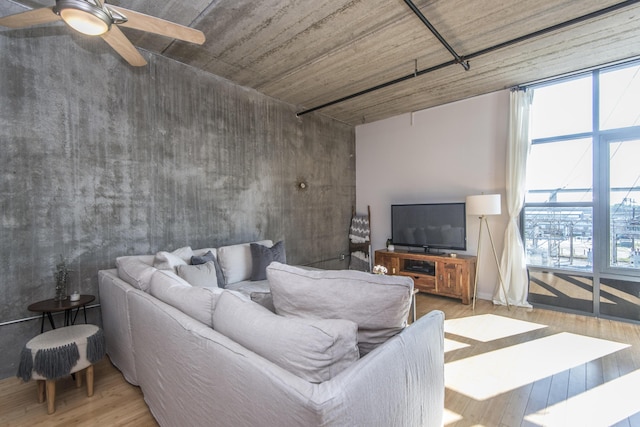 living room with ceiling fan and hardwood / wood-style floors