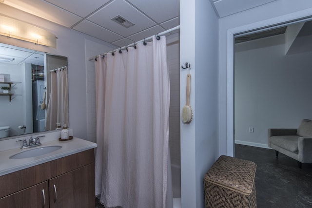 bathroom featuring shower / bath combo with shower curtain, a paneled ceiling, and vanity