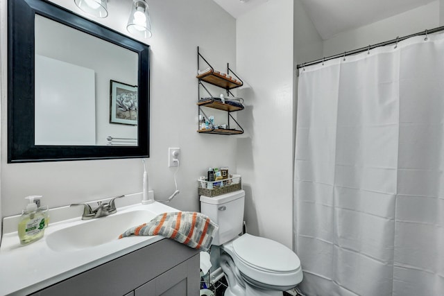 bathroom featuring toilet, a shower with shower curtain, and vanity