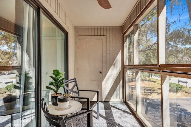 unfurnished sunroom featuring ceiling fan