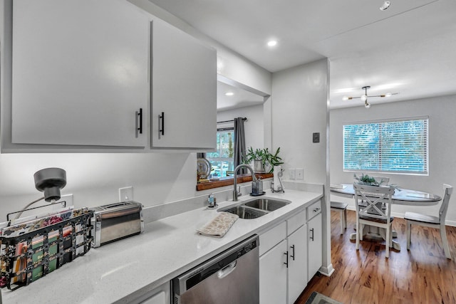 kitchen with recessed lighting, white cabinets, a sink, wood finished floors, and dishwasher