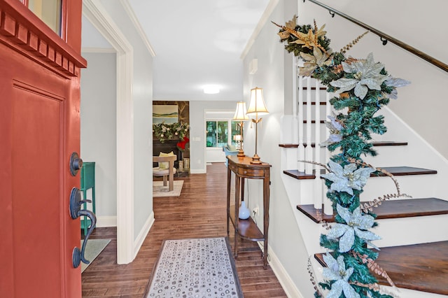 entrance foyer with dark hardwood / wood-style floors and ornamental molding