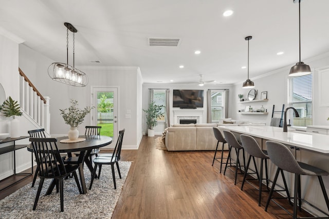 2267 Kemmerlin St, Johns Island, SC 29455 - dining room featuring crown molding, dark wood-style floors, stairway, a ceiling fan, and recessed lighting
