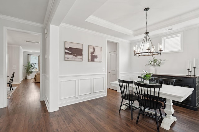 2267 Kemmerlin St, Johns Island, SC 29455 - dining room featuring a chandelier, dark wood-type flooring, wainscoting, ornamental molding, and a raised ceiling
