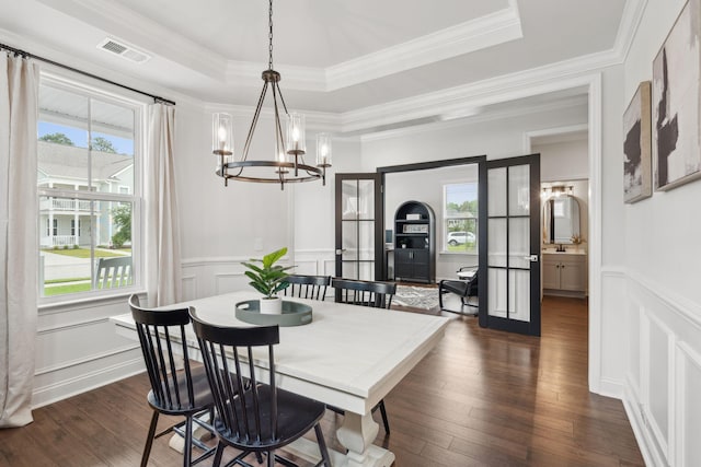 2267 Kemmerlin St, Johns Island, SC 29455 - dining area with a chandelier, a decorative wall, healthy amount of natural light, dark wood-style floors, and a raised ceiling