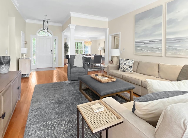 2655 Gnarled Pne, Seabrook Island, SC 29455 - living room featuring decorative columns, light wood finished floors, ornamental molding, and a chandelier
