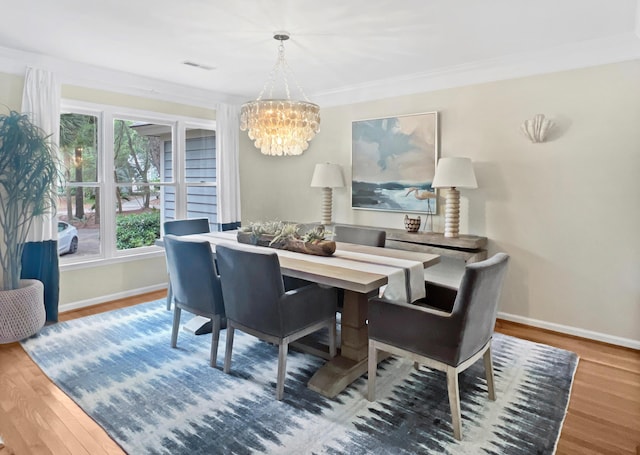 2655 Gnarled Pne, Seabrook Island, SC 29455 - dining space featuring a chandelier, baseboards, wood finished floors, and crown molding