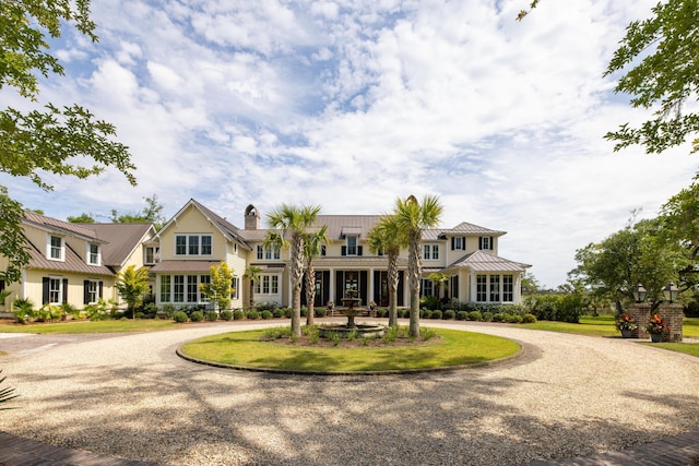 4855 Retriever Rd, Wadmalaw Island, SC 29487 - view of front of house featuring curved driveway, a standing seam roof, metal roof, and a chimney