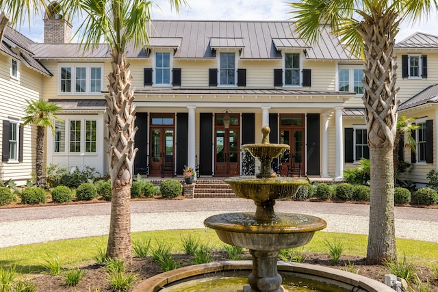 4855 Retriever Rd, Wadmalaw Island, SC 29487 - rear view of house with a standing seam roof, metal roof, french doors, and a chimney