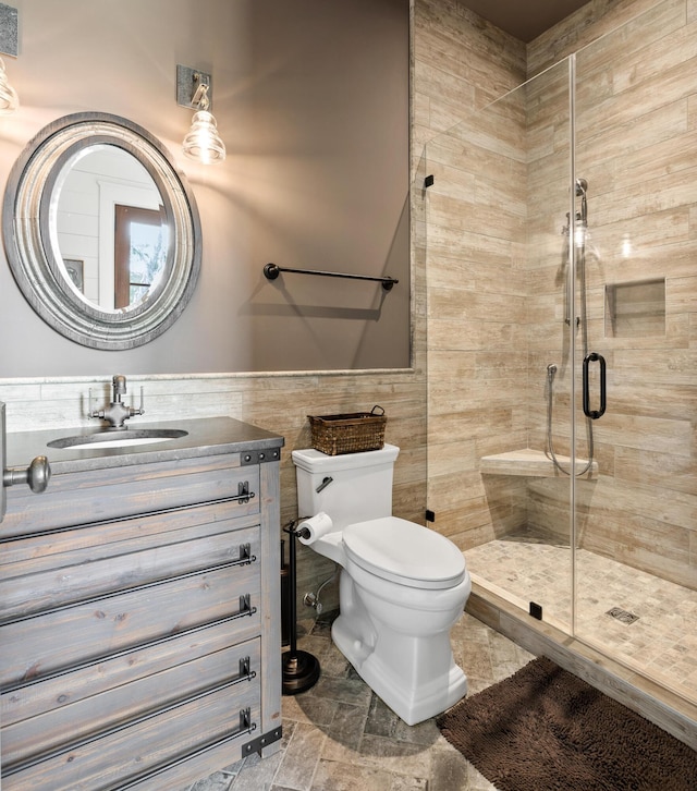 4855 Retriever Rd, Wadmalaw Island, SC 29487 - full bath with a stall shower, toilet, tile walls, vanity, and wainscoting