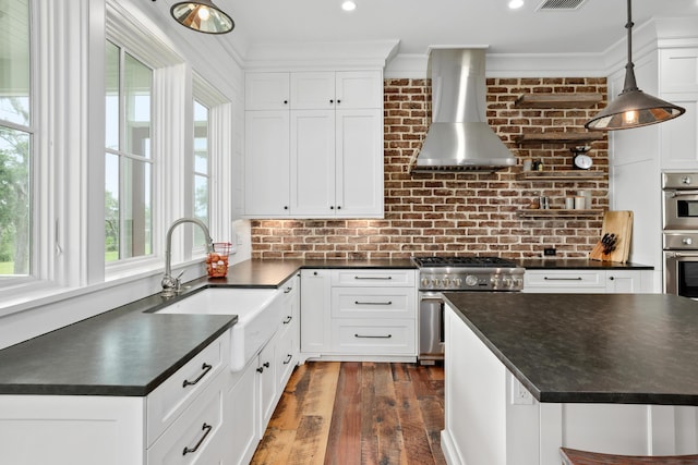 4855 Retriever Rd, Wadmalaw Island, SC 29487 - kitchen featuring wall chimney range hood, dark countertops, stainless steel appliances, a sink, and dark wood-type flooring