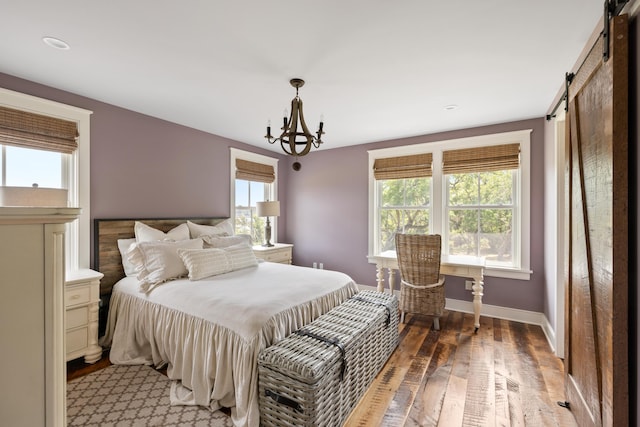 4855 Retriever Rd, Wadmalaw Island, SC 29487 - bedroom with a barn door, light wood-type flooring, a chandelier, and baseboards