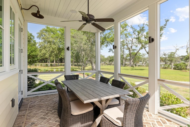 4855 Retriever Rd, Wadmalaw Island, SC 29487 - sunroom featuring ceiling fan, outdoor dining area, and view of scattered trees
