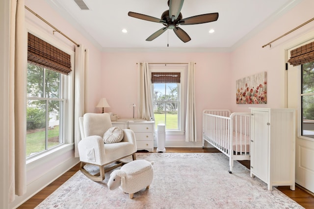 4855 Retriever Rd, Wadmalaw Island, SC 29487 - bedroom with multiple windows, a crib, dark wood-style floors, ceiling fan, and crown molding