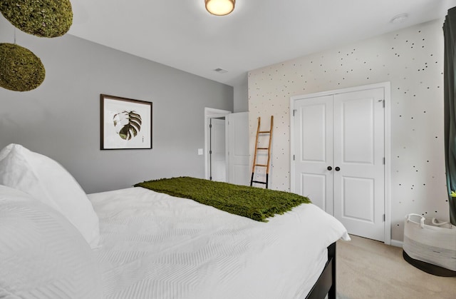 carpeted bedroom with a closet