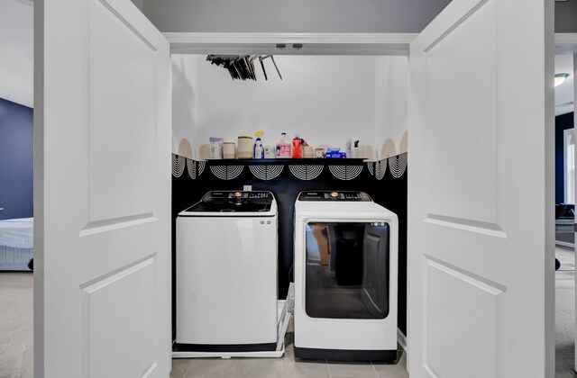 washroom featuring washing machine and dryer and light tile patterned floors