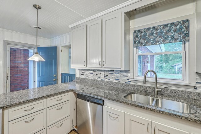 4729 Lang Ridge Dr, North Charleston, SC 29405 - kitchen with stainless steel dishwasher, a sink, crown molding, decorative light fixtures, and dark stone counters