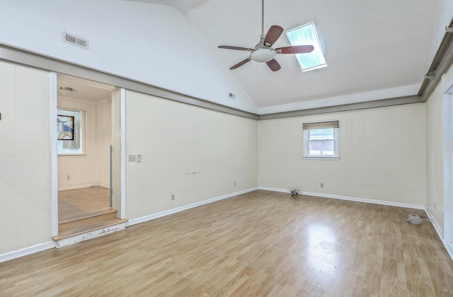 4729 Lang Ridge Dr, North Charleston, SC 29405 - empty room with ceiling fan, wood finished floors, high vaulted ceiling, a skylight, and baseboards