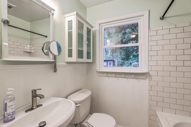 4729 Lang Ridge Dr, North Charleston, SC 29405 - bathroom with a sink, toilet,  shower combination, and a wainscoted wall