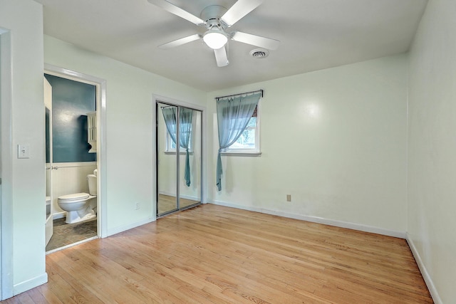4729 Lang Ridge Dr, North Charleston, SC 29405 - unfurnished bedroom featuring light wood-type flooring, ensuite bathroom, baseboards, and a ceiling fan
