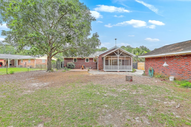 4729 Lang Ridge Dr, North Charleston, SC 29405 - rear view of property with a sunroom, brick siding, and a fenced backyard