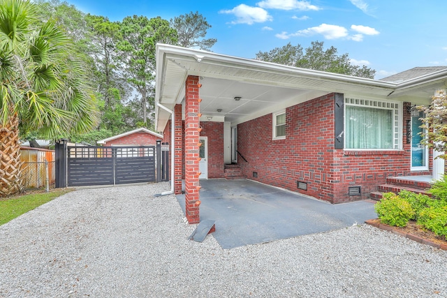 4729 Lang Ridge Dr, North Charleston, SC 29405 - view of side of home featuring crawl space, driveway, a gate, brick siding, and a carport