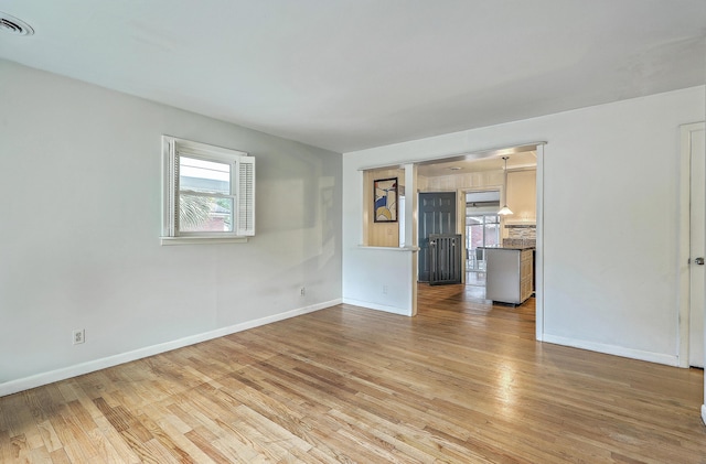 4729 Lang Ridge Dr, North Charleston, SC 29405 - unfurnished living room with light wood-style floors and baseboards