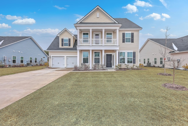 view of front of property with a garage, a balcony, cooling unit, and a front lawn