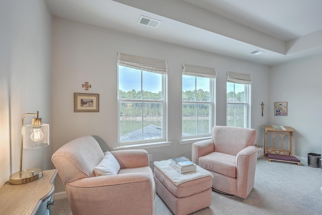 living area featuring light carpet