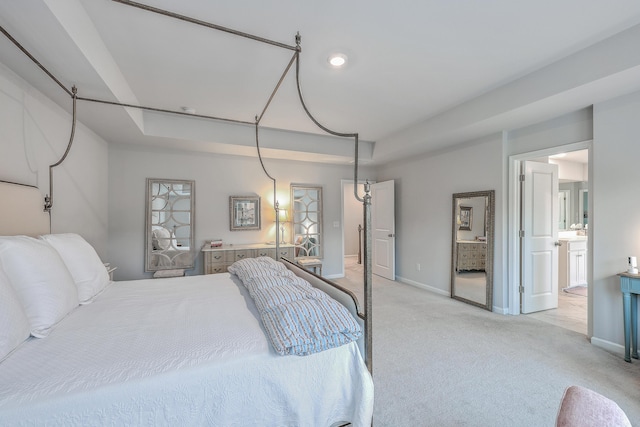 carpeted bedroom with connected bathroom