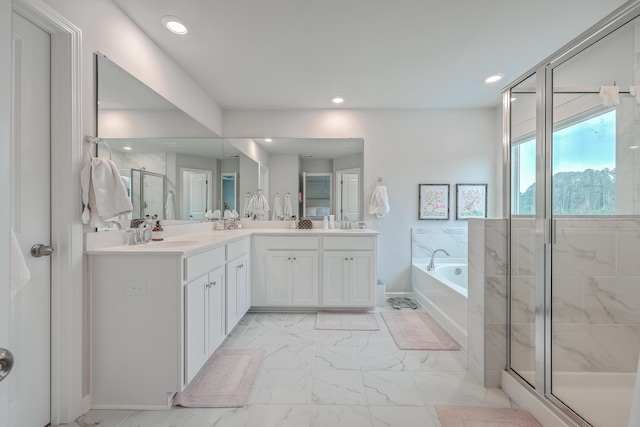 bathroom featuring vanity and separate shower and tub