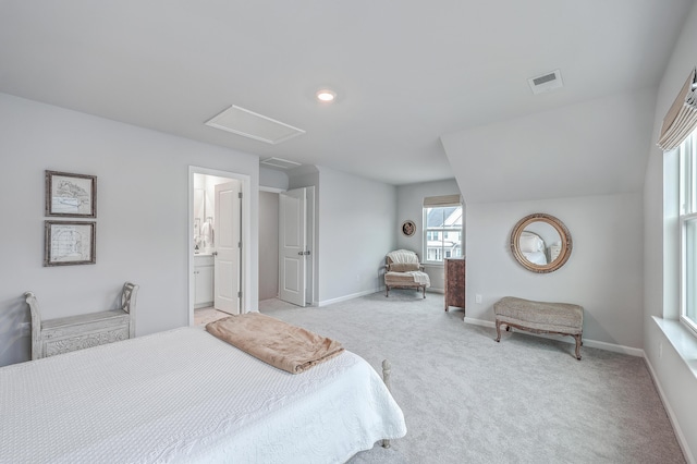 bedroom featuring light colored carpet and connected bathroom