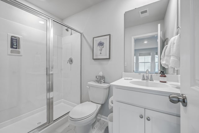 bathroom featuring an enclosed shower, vanity, and toilet