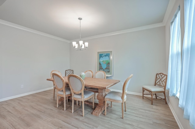 dining space featuring crown molding and an inviting chandelier