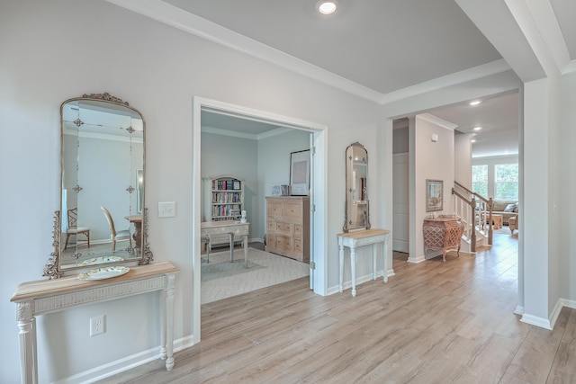 corridor featuring ornamental molding and light hardwood / wood-style flooring