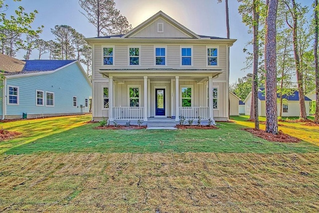 view of front of home featuring a front lawn and board and batten siding