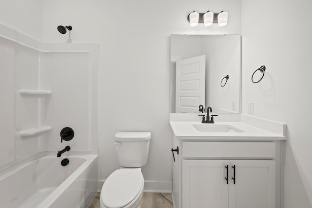 bathroom featuring baseboards, toilet,  shower combination, marble finish floor, and vanity