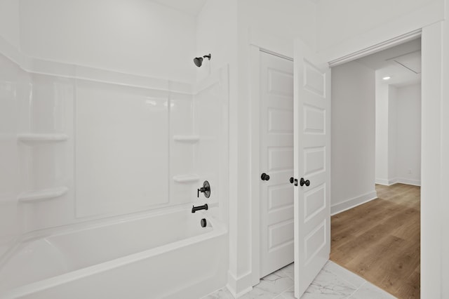 full bathroom featuring  shower combination, marble finish floor, and baseboards