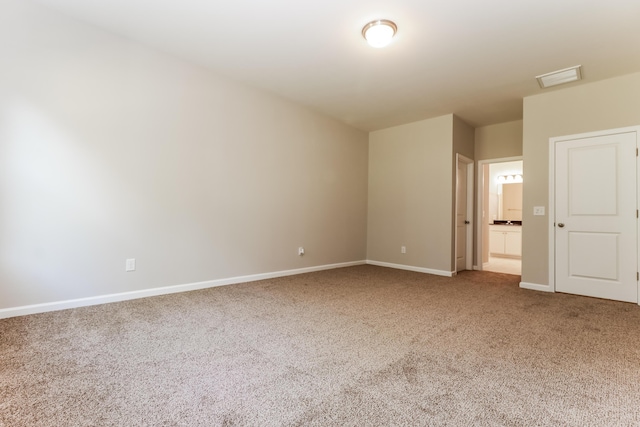 unfurnished room featuring carpet floors, baseboards, and visible vents