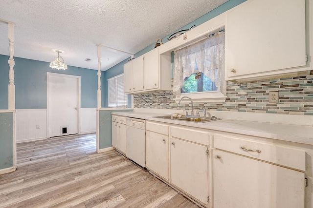 4606 Moss Ct, North Charleston, SC 29420 - kitchen featuring white dishwasher, light countertops, a sink, a textured ceiling, and light wood-style floors