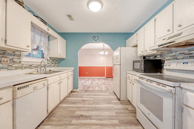 4606 Moss Ct, North Charleston, SC 29420 - kitchen featuring white appliances, a sink, extractor fan, arched walkways, and a textured ceiling