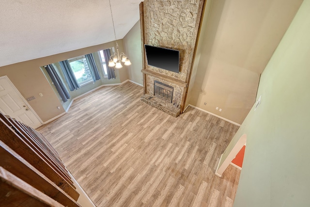 4606 Moss Ct, North Charleston, SC 29420 - unfurnished living room featuring lofted ceiling, a chandelier, baseboards, light wood-style floors, and a fireplace
