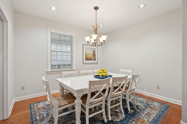 dining space featuring a notable chandelier and wood-type flooring